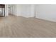 Bright, open-concept space showcasing hardwood floors and access to the kitchen at 16062 W Prickly Pear Trl, Surprise, AZ 85387