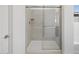 Modern shower with a glass enclosure and light colored tile at 16062 W Prickly Pear Trl, Surprise, AZ 85387