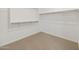 Bright, carpeted walk-in closet with built-in shelving and ample space at 16062 W Prickly Pear Trl, Surprise, AZ 85387