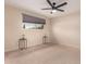 Serene bedroom featuring neutral tones, plush carpet, ceiling fan, and a window providing natural light at 4937 N Granite Reef Rd, Scottsdale, AZ 85251