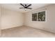 Bright and spacious bedroom with carpet flooring, a large window, and a ceiling fan for comfortable living at 4937 N Granite Reef Rd, Scottsdale, AZ 85251