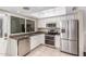 Well-lit kitchen with stainless steel appliances, white cabinetry, granite countertops, and a double oven at 4937 N Granite Reef Rd, Scottsdale, AZ 85251