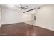 Spacious living room featuring a painted brick wall, hardwood floors, and recessed lighting with a modern ceiling fan at 4937 N Granite Reef Rd, Scottsdale, AZ 85251