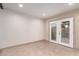 Bright living area featuring white brick wall, tile flooring, and French doors, perfect for indoor-outdoor living at 4937 N Granite Reef Rd, Scottsdale, AZ 85251