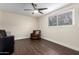 Cozy living space with dark wood floors, comfortable seating, and a window for natural light and street views at 4937 N Granite Reef Rd, Scottsdale, AZ 85251