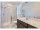 Modern bathroom featuring a walk-in shower, large mirror, and vanity with countertop at 25153 N 177Th Dr, Surprise, AZ 85387