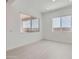 Clean bedroom with tile floors, white walls, and ample natural light from the large window at 25153 N 177Th Dr, Surprise, AZ 85387