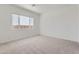 Clean bedroom featuring neutral carpet and ample natural light from the large window at 25153 N 177Th Dr, Surprise, AZ 85387