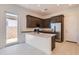 Modern kitchen featuring stainless steel appliances, an island with a sink, and tile floors at 25153 N 177Th Dr, Surprise, AZ 85387