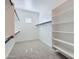 Spacious walk-in closet with built-in shelving and hanging rods, providing ample storage space at 25153 N 177Th Dr, Surprise, AZ 85387