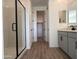 Elegant bathroom with gray cabinets and walk-in shower at 4267 E Bradford Ave, San Tan Valley, AZ 85143