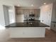 Modern kitchen with gray cabinets, dark countertops, and island at 4267 E Bradford Ave, San Tan Valley, AZ 85143