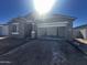 New construction home with large garage and stone accents, bathed in sunlight at 4317 E Bradford Ave, San Tan Valley, AZ 85143