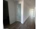 Bright hallway with wood-look tile floors leading to various rooms at 4317 E Bradford Ave, San Tan Valley, AZ 85143