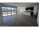 Open-concept living room with large sliding glass doors and black kitchen cabinets at 4317 E Bradford Ave, San Tan Valley, AZ 85143