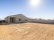 Backyard view, featuring a home with gray stucco and a large, unfinished yard space at 4832 N 177Th Dr, Goodyear, AZ 85395