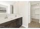 Modern bathroom with a double sink vanity, ample storage, and tile flooring, designed for convenience and style at 4832 N 177Th Dr, Goodyear, AZ 85395