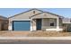 Charming single-story home with a blue garage door, gray trim and a nicely paved driveway at 4832 N 177Th Dr, Goodyear, AZ 85395