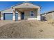 Well-maintained front exterior features a two car garage and a inviting covered porch at 4832 N 177Th Dr, Goodyear, AZ 85395