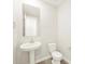 Well-lit powder room featuring a pedestal sink, modern fixtures, and a clean, minimalist design for guests at 4832 N 177Th Dr, Goodyear, AZ 85395