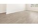 Neutral-toned room featuring wood-look tiled floors and bright white walls at 4832 N 177Th Dr, Goodyear, AZ 85395