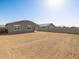 Large backyard space with a block wall, offering privacy for outdoor activities and landscaping at 4862 N 177Th Dr, Goodyear, AZ 85395