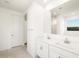 Bright bathroom featuring double sinks, a large mirror, and a private toilet area at 4862 N 177Th Dr, Goodyear, AZ 85395