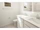 Bright bathroom featuring double sinks, white cabinetry, a large mirror, and modern fixtures at 4862 N 177Th Dr, Goodyear, AZ 85395