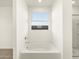 Well-lit bathroom featuring a soaking tub, a shower, and a window for natural light at 4862 N 177Th Dr, Goodyear, AZ 85395