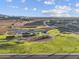 Aerial view of a park with a playground, sports courts, and walking paths in a new community at 4862 N 177Th Dr, Goodyear, AZ 85395