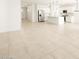 Open living space showcasing sleek tile flooring and a modern kitchen at 4862 N 177Th Dr, Goodyear, AZ 85395