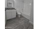 Clean bathroom featuring a bathtub and granite countertop at 6943 W Monterey Way, Phoenix, AZ 85033