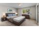 Cozy bedroom with a brown leather bed frame and striped bedding at 8119 E Desert Trl, Mesa, AZ 85208