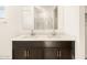 Double vanity bathroom with modern dark brown cabinets at 9121 N 173Rd Ln, Waddell, AZ 85355