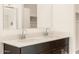 Double sink bathroom vanity with modern dark brown cabinets at 9121 N 173Rd Ln, Waddell, AZ 85355