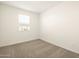 Simple bedroom with carpet, window and double door closet at 9121 N 173Rd Ln, Waddell, AZ 85355