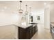 Large kitchen island with granite countertop and dark cabinets at 9121 N 173Rd Ln, Waddell, AZ 85355