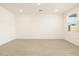 Bright and airy living room with neutral walls and wood-look floors at 9121 N 173Rd Ln, Waddell, AZ 85355