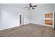 Bedroom with ceiling fan and access to the backyard at 10813 W Piute Ave, Sun City, AZ 85373