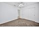 Bright bedroom with ceiling fan and double sliding door closet at 10813 W Piute Ave, Sun City, AZ 85373