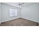 Simple bedroom with ceiling fan and carpet flooring at 10813 W Piute Ave, Sun City, AZ 85373