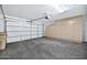 Garage interior with storage cabinets and automatic door opener at 10813 W Piute Ave, Sun City, AZ 85373