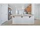 Kitchen island with tile countertop and wood cabinets at 10813 W Piute Ave, Sun City, AZ 85373