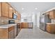 Kitchen with wood cabinets, stainless steel appliances, and tile floors at 10813 W Piute Ave, Sun City, AZ 85373