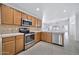 Modern kitchen with wood cabinets and stainless steel appliances at 10813 W Piute Ave, Sun City, AZ 85373