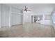 Bright living room with tile floors and ceiling fan at 10813 W Piute Ave, Sun City, AZ 85373