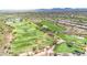 Panoramic aerial view of a community with golf courses, lush green fairways, and residential homes at 2740 W Plum Hollow Dr, Anthem, AZ 85086