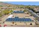 Overhead shot showing houses in the neighborhood with tile roofs and solar panels at 2740 W Plum Hollow Dr, Anthem, AZ 85086