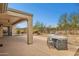 Backyard featuring a built-in bar-b-que, covered patio and views of desert landscaping at 2740 W Plum Hollow Dr, Anthem, AZ 85086