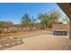 Backyard featuring a concrete patio, custom barbecue, and low desert landscaping at 2740 W Plum Hollow Dr, Anthem, AZ 85086